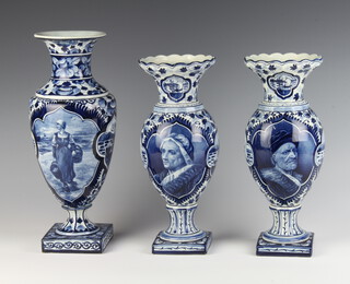A pair of Delft baluster vases decorated with portrait panels 27cm together with a taller ditto decorated with a figure 30cm 