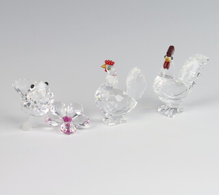 A Swarovski Crystal figure of a cockerel 4.5cm, ditto chicken 4cm and a bird beside a flower 4cm 