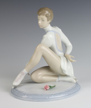 A Lladro figure of a seated ice skater with a rose beside her 6653 21cm 