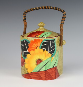 An Art Deco Crown Devon octagonal biscuit barrel and cover decorated with stylised flowers and wicker handle 16cm 