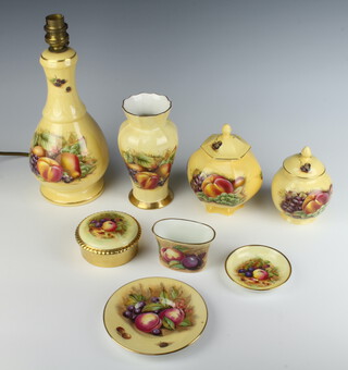 An Aynsley Orchard Gold vase decorated with fruits 16cm, a bulbous lidded ditto jar 11cm, a hexagonal ditto with lid 13cm, a spill vase 6cm, circular box 8cm, dish 12cm, pin tray 8cm and table lamp 27cm 
