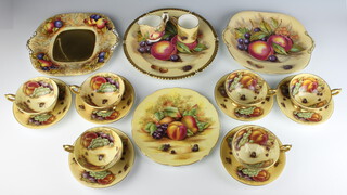 An Aynsley part tea set decorated with fruits comprising 6 saucers, 6 tea cups, coffee can, milk jug, 2 serving plates, side plate and a decorative wall plate