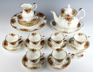A Royal Albert Old Country Rose tea set comprising 6 saucers, 6 tea cups, sugar bowl, cream jug, teapot, serving plate, cake stand and 6 side plates together with a similar shoe (all pieces are seconds) 