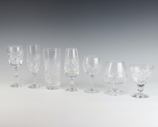 A set of cut glass drinking glasses comprising 10 wine glasses, 11 brandies, 3 highballs, 5 champagnes