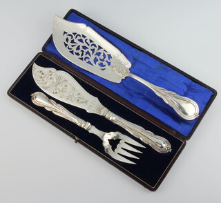 An Edwardian silver plated lily pattern fish slice together with a cased pair of fish servers 
