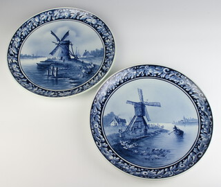 A pair of Delft plates decorated with windmills 31cm