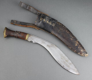 A military style Kukri with 28cm unmarked blade contained in a leather scabbard with leather frog
