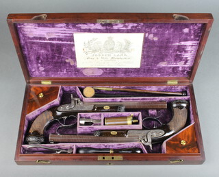 Joseph Lang, a cased pair of early 19th Century 44 bore percussion pistols (converted from flintlock), both blued octagonal barrels stamped with London company and view proof marks and engraved "I Lang Haymarket".  The pistols numbered 1 and 2 on the breach and numbered 465 and 466 on the trigger guard respectively.  The stocks and grips in walnut, the grips having checkered pattern with bright steel roccoco buttcaps.  The lock plate and hammer engraved with floral design.  The walnut case fitted with label of "Joseph Lang, 22 Cockspur Street" and containing ball mould, 2 turnscrews, wadding punch, copper and brass powder flask, cleaning rod, mallet. The case having having two compartments containing oiler, a bone brush and a collection of shot