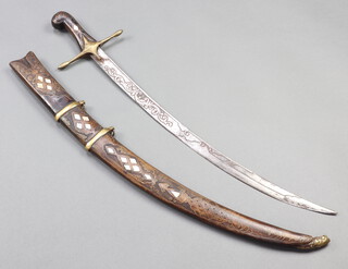 An Indian mameluke style sword with 61cm etched blade contained in a hardwood and inlaid mother of pearl scabbard