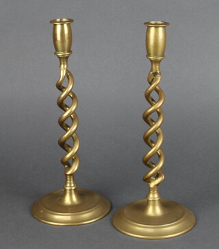 A pair of Victorian brass spiral candlesticks, raised on circular spreading feet 30cm h x 12cm diam. 