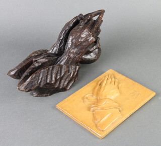 A rectangular carved lime wood plaque decorated a pair of clasped hands in prayer marked A D 19cm h x 14cm w together with a carved oak sculpture of clasped hands in prayer 34cm h x 12cm 