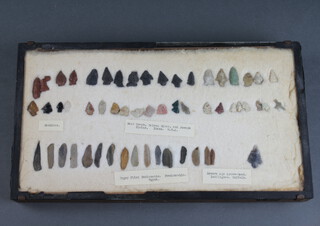 A collection of 56 bronze age and later arrow heads contained in a pine frame 4cm x 42cm x 23cm 