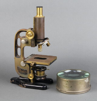 C Baker, a brass single pillar microscope RD.742647 together with a large circular lens 6cm x 14cm 