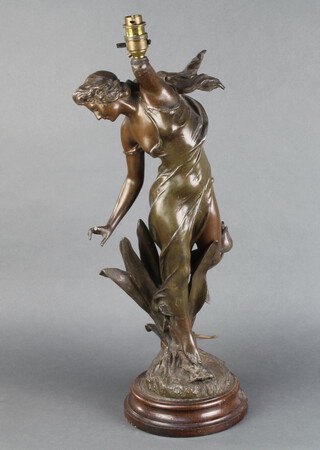 An Art Nouveau spelter figure of a standing lady, raised on a circular oak base, converted to a table lamp 63cm h x 19cm diam. 
