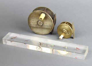 Maclean Inverness, a 19th Century brass centre pin fishing reel 4", together with a Stewart & Son Aberlour brass centre pin reel 2.5" and a perspex 12" ruler set 6 flies 