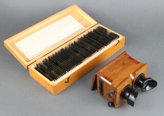 A Standard stereoscope viewer in a mahogany case together with 46 various glass slides 