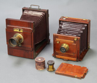 A Rouch-Rouchs Patent mahogany and brass tailboard camera manufactured by MWW Rouch & Co of London, with beck primus lens with red bellows and 1 other with red bellows and unmarked lens 