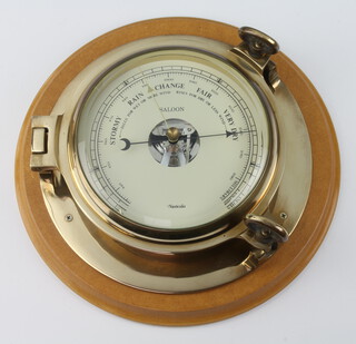 A Nauticalia ships style aneroid barometer contained in a gilt metal case 10cm x 27cm, the dial marked Saloon  