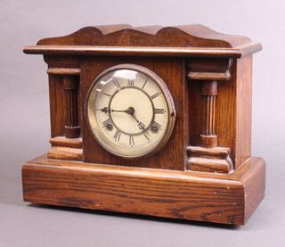 A Waterbury Clock Company 19th Century, 8 day striking clock with paper dial and Roman numerals, contained in an oak architectural case, with pendulum but no key, 29cm h x 35cm w x 14cm d  