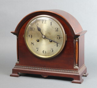 An Edwardian striking mantel clock with 16cm silvered dial and Arabic numerals, contained in a arched shaped mahogany case, raised on ogee bracket feet, 29cm x 31cm x 13cm, complete with pendulum and key 
