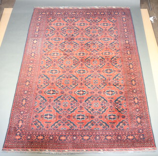 A red and blue ground Afghan carpet with all-over geometric design 282cm x 212cm 
