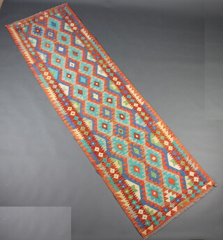 A blue, turquoise and orange ground Chobi Kilim runner with all-over geometric designs 293cm x 84cm 