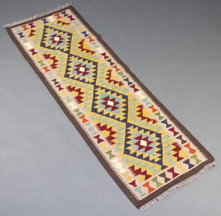 A black, green and brown ground Maimana Kilim runner with 4 diamonds to the centre 197cm x 64cm 