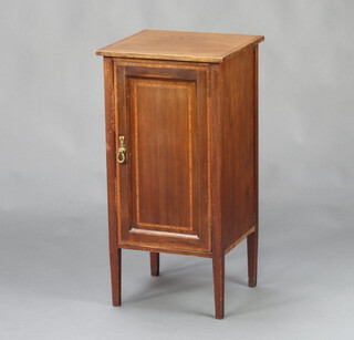 An Edwardian mahogany bedside cabinet with crossbanded top, enclosed by a panelled door, raised on square tapered supports 76cm h x 38cm w x 35cm d 