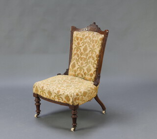 A Victorian carved walnut showframe nursing chair upholstered in yellow sculptured material, raised on turned supports 90cm h x 54cm w x 43cm d (seat 34cm x 30cm) 