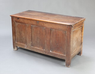 A 17th/18th Century oak coffer of panelled construction and hinged lid, the interior fitted a candle box 71cm h x 125cm w x 56cm d 