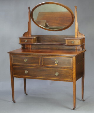 An Edwardian inlaid mahogany dressing table with oval bevelled plate mirror, the base fitted 2 glove drawers, 2 short and 2 long drawers, raised on square tapered supports ending in ceramic casters 153cm h x 107cm w x 49cm d 