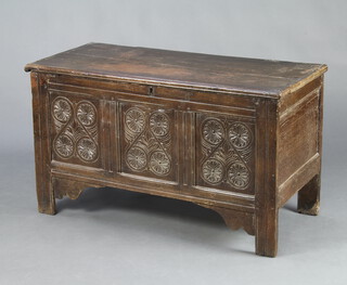 A 17th/18th Century oak coffer with hinged lid and carved panels to the front 71cm h x 124cm w x 56cm d 
