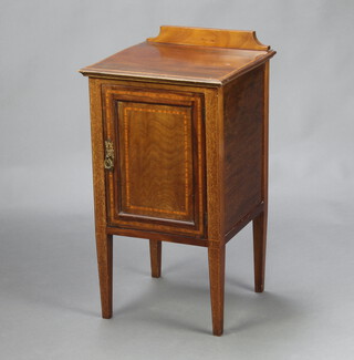 An Edwardian inlaid mahogany bedside cabinet with raised back enclosed by a panelled door, raised on square tapered supports 78cm h x 41cm w x 40cm d 