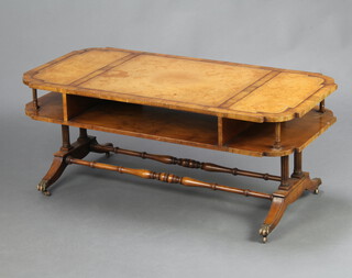 A Georgian style shaped mahogany 2 tier coffee table with inset writing surface, raised on 4 turned columns, splayed feet, brass caps and casters 44cm h x 107cm w x 50cm d 