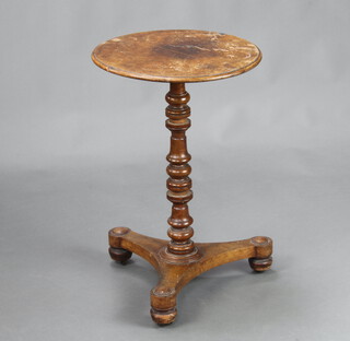 A William IV circular walnut quarter veneered wine table, raised on a turned column, triform base, bun feet 69cm h x 45cm diam. 
