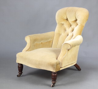 A Victorian armchair upholstered in yellow buttoned material, raised on turned supports 88cm h x 67cm w x 75cm d (seat 39cm x 49cm)  