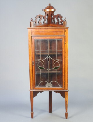 An Edwardian Art Nouveau inlaid mahogany corner cabinet, the upper section with pierced gallery, fitted shelves enclosed by lead glazed panelled doors, raised on square tapered supports, spade feet 166cm h x 57cm w x 41cm d 