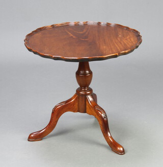 A Georgian style circular mahogany wine table with pie crust edge, raised on turned tripod and pillar supports 45cm h x 50cm diam. 