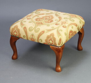 A 20th Century Victorian style footstool upholstered in floral material, raised on cabriole supports 30cm h x 49cm w x 50cm d 