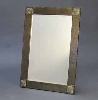 An Edwardian Art Nouveau bevelled plate wall mirror contained in a planished and verdigris frame 74cm h x 52cm w 
