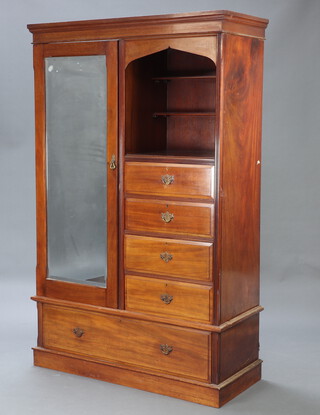 An Edwardian mahogany combination wardrobe enclosed by bevelled plate mirrored door flanked by a recess fitted 2 shelves above 4 drawers, the base fitted a drawer 202cm h x 128cm w x 53cm w 
