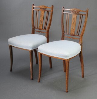 A pair of Victorian inlaid rosewood slat back bedroom chairs with over stuffed seats, raised on square tapered supports 85cm h x 43cm w  x 41cm d (seat 28cm x 29cm) 
