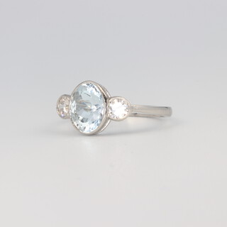 A platinum aquamarine and diamond ring, the centre oval stone 1.2ct, the 2 brilliant cut diamonds 0.42ct, size K 1/2, 4.3 grams 