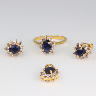 A suite of yellow metal jewellery comprising a sapphire and diamond ring size K 1/2, a pair of ear studs and pendant 7.7 grams gross 