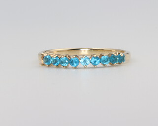 A 9ct yellow gold topaz half eternity ring size N, 1.2 grams 