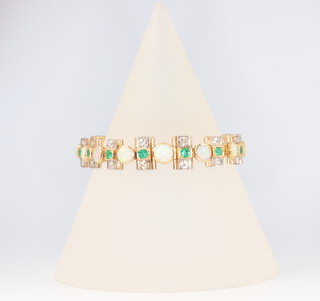 A yellow metal bracelet set with 30 brilliant cut diamonds each approx. 0.05ct, 13 brilliant cut emeralds each approx. 0.05ct and 14 circular cut opals each approx 0.04ct, 30.7 grass gross 