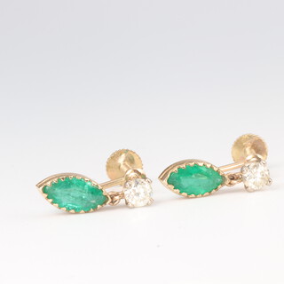 A pair of yellow metal, 9ct, emerald and diamond ear drops, the brilliant cut diamonds each 0.25ct, the elliptical cut emeralds 13mm x 4mm, in total 18mm, 2.1 grams 