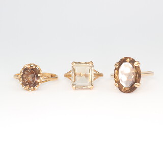 Three 9ct smoky quartz rings, size L 1/2, O 1/2 and Q, 10.6 grams 