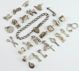 A collection of silver charms 68 grams 