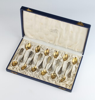 A set of 12 German 800 standard coffee spoons with gilt bowls in a fitted velvet case, 104 grams
